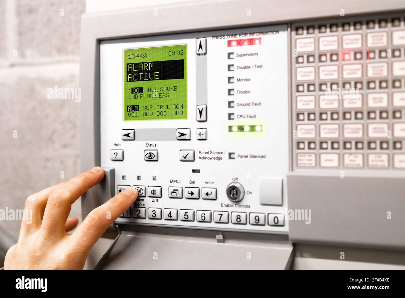 Fire alarm control panel is activated and in alert mode. Display