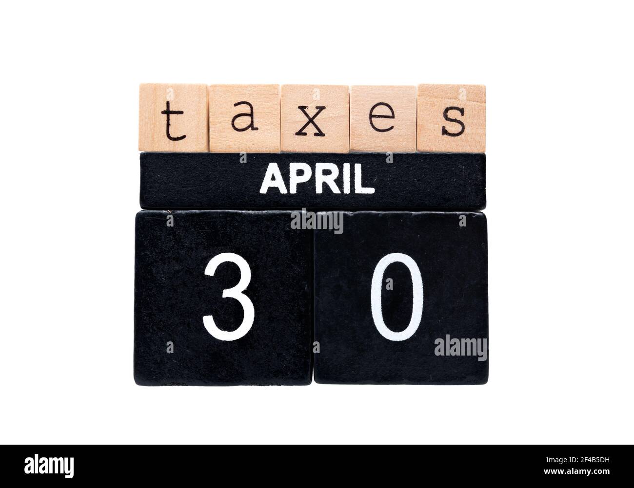Taxes April 30 spelled with wood block letters. Concept for tax return deadline for individual tax returns in Canada. Light brown and black wood block Stock Photo