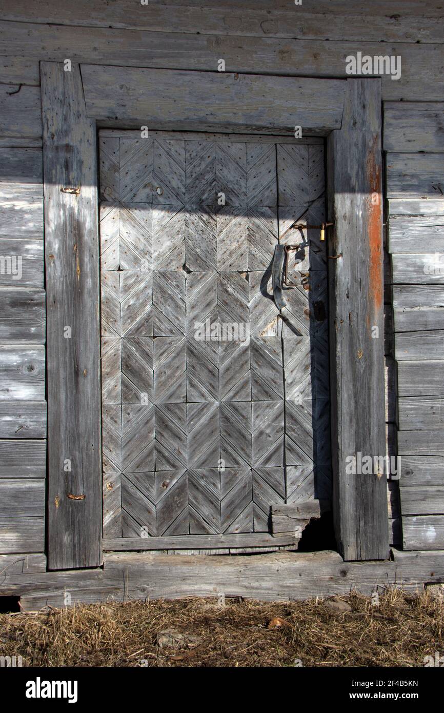 Historical old used wooden ornamental barn door Stock Photo