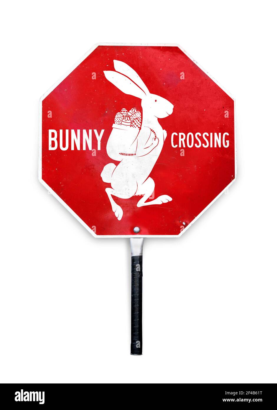 Stop bunny crossing sign. Silhouette of rabbit with basket filled with Easter eggs. Easter themed stop sign used to control traffic. Red and white met Stock Photo