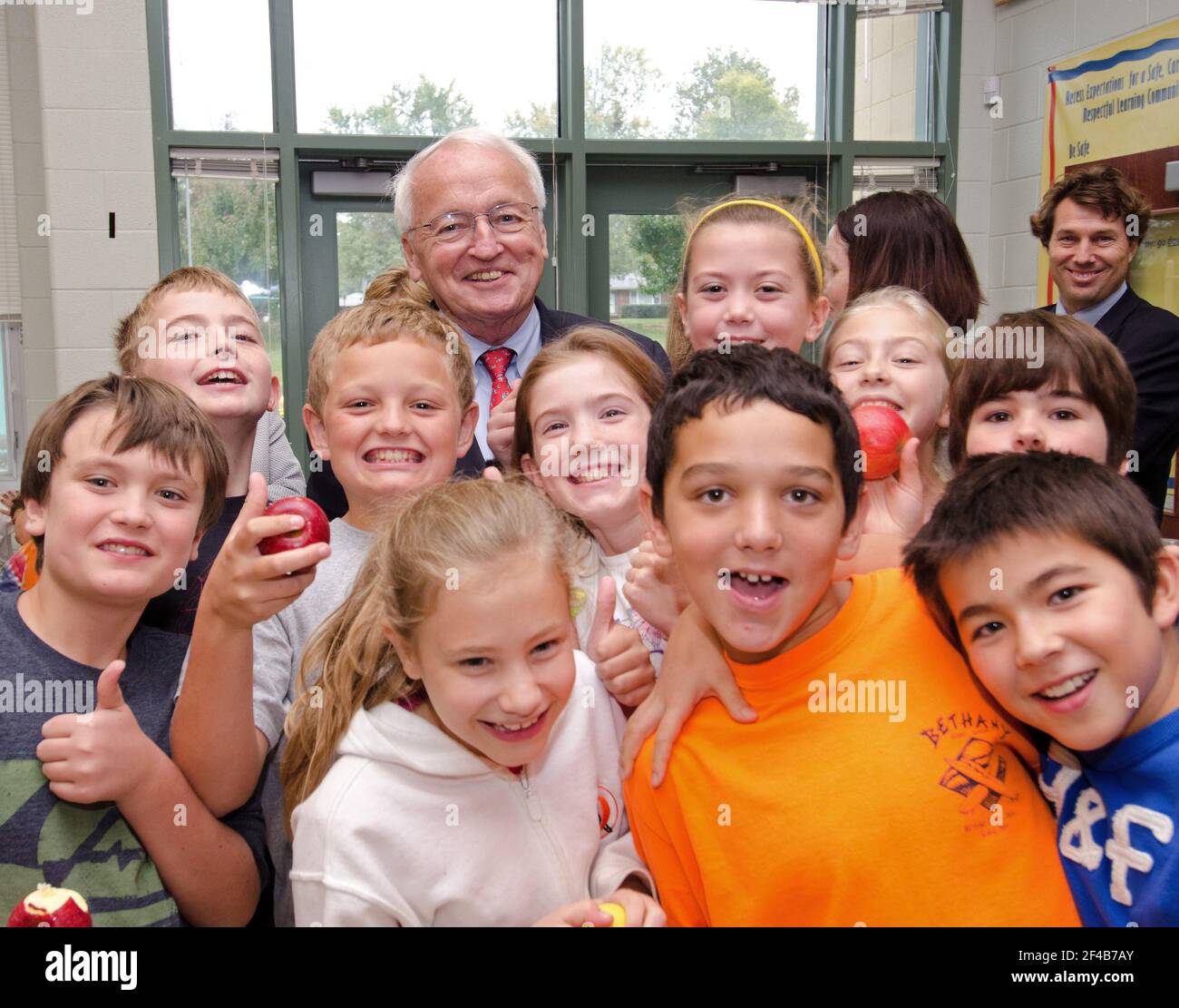 Several students stopped to have a photo taken with Under Secretary for Food, Nutrition and Consumer Services Kevin Concannon (backrow c.) during his visit to Nottingham Elementary School in Arlington, VA, on Wednesday, October 12, 2011. The apples, they are eating, are from Big Rigg farm, and were very popular with the students. Stock Photo