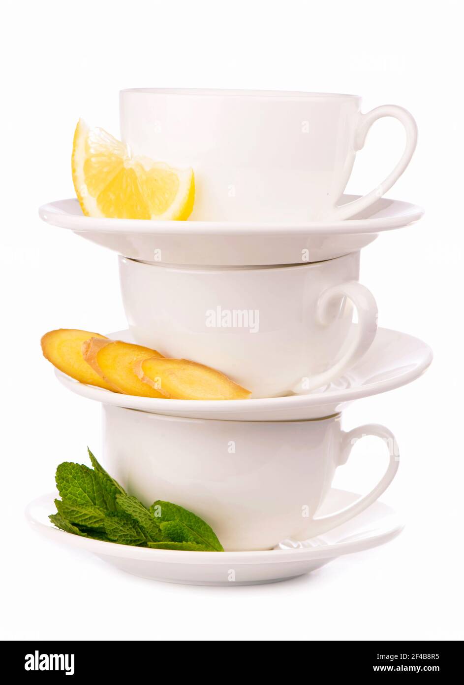 Creative layout made of cup of mint tea, lemon, ginger on a white background. Top view. Stock Photo