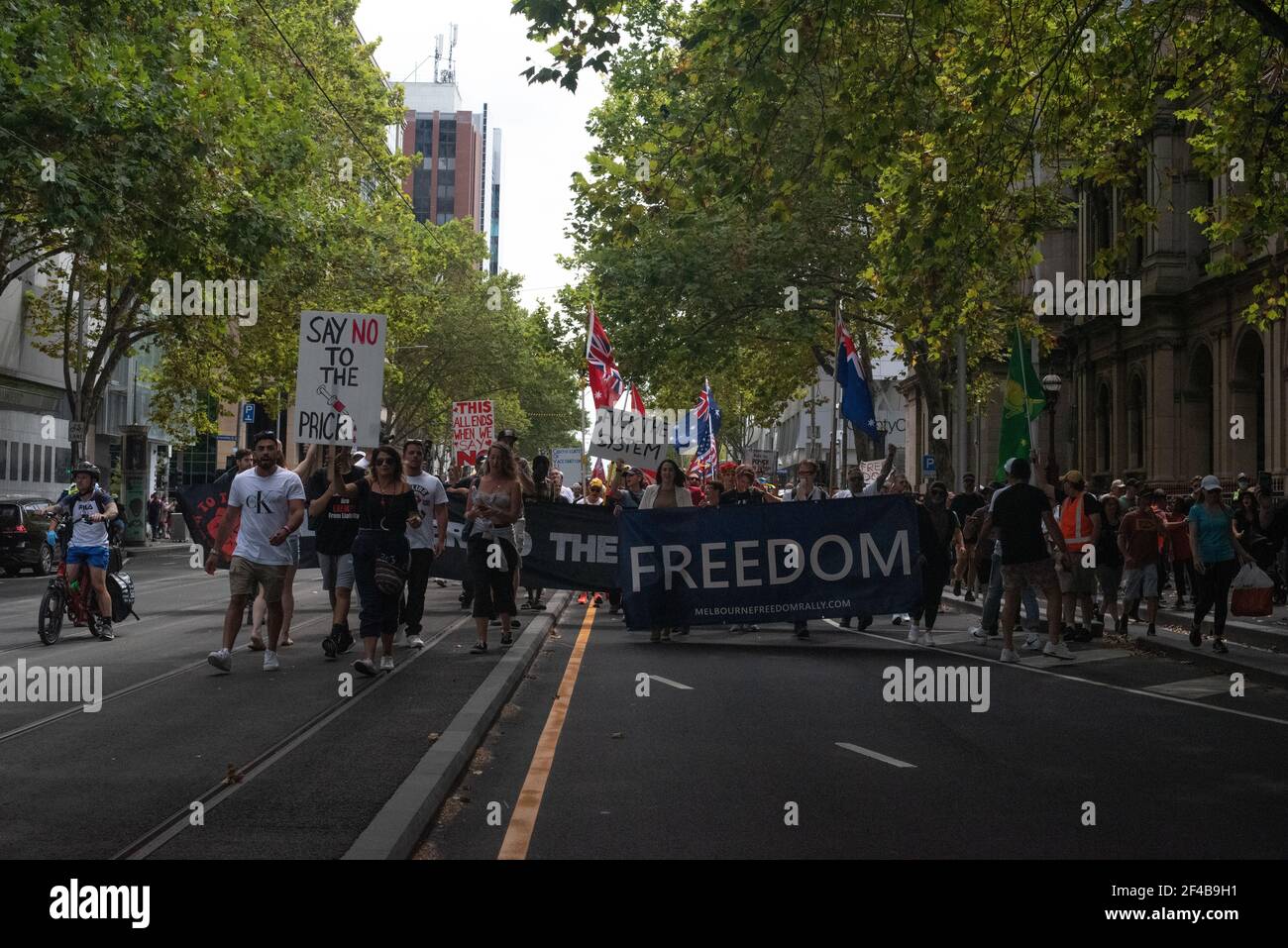 Melbourne, Australia. 20th Mar 2021. Freedom protesters march down William Street at a worldwide rally for freedom against the COVID-19 vaccination. March 20, Melbourne, Australia. Credit: Jay Kogler/Alamy Live News Stock Photo