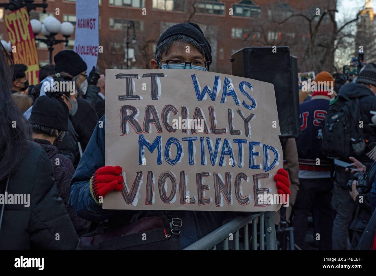 NEW YORK, NY - MARCH 19: A Protestor holds a sign that reads 'it was racially motivated violence' at a peace vigil to honor victims of attacks on Asians in Union Square Park on March 19, 2021 in New York City. On March 16th, eight people were killed at three Atlanta, Georgia area spas, six of whom were Asian women, in an attack that sent terror through the Asian community. Credit: Ron Adar/Alamy Live News Stock Photo