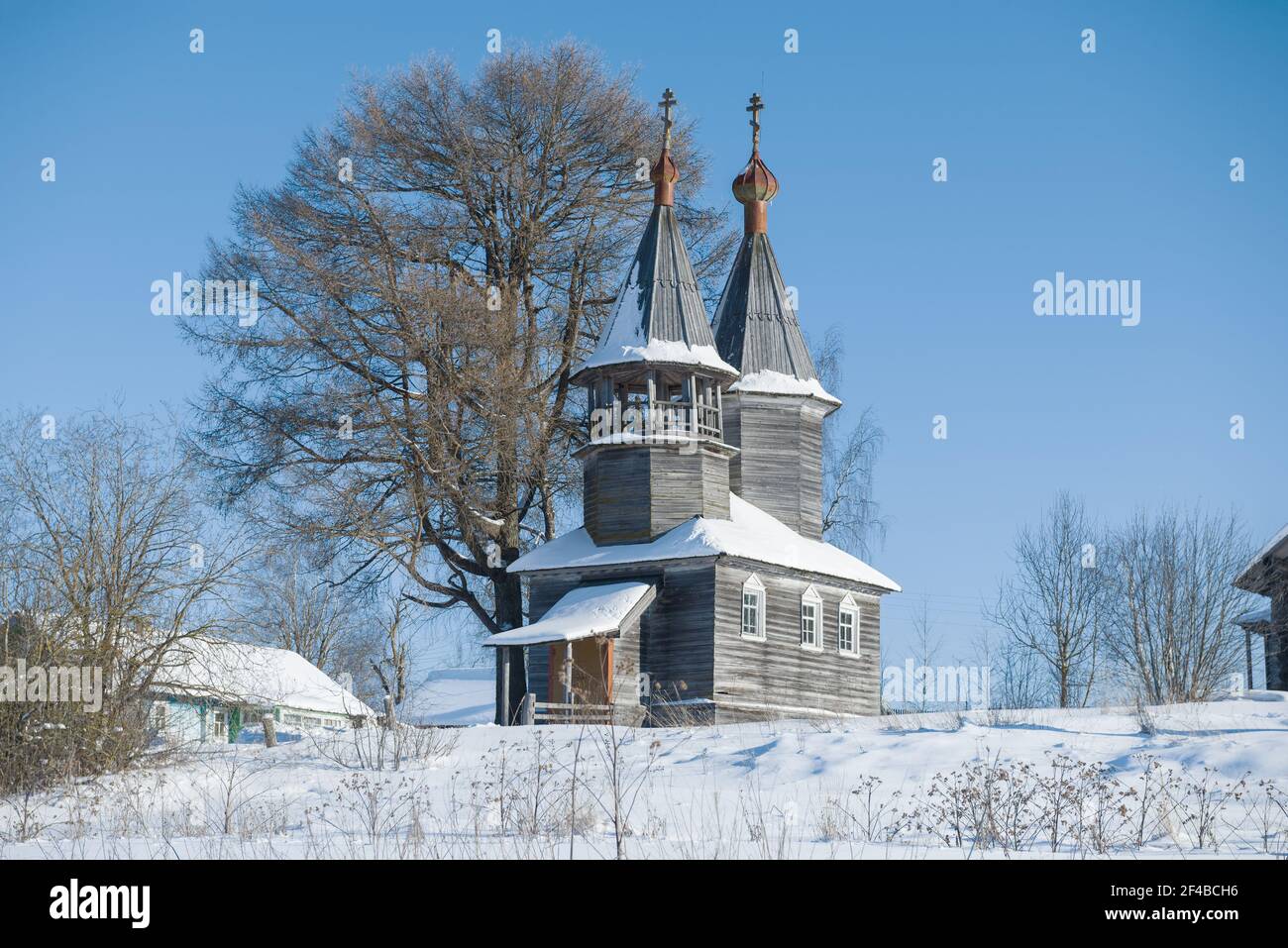 Old wooden chapel of St. George the Victorious on a frosty February day. Arkhangelsk region, Russia Stock Photo