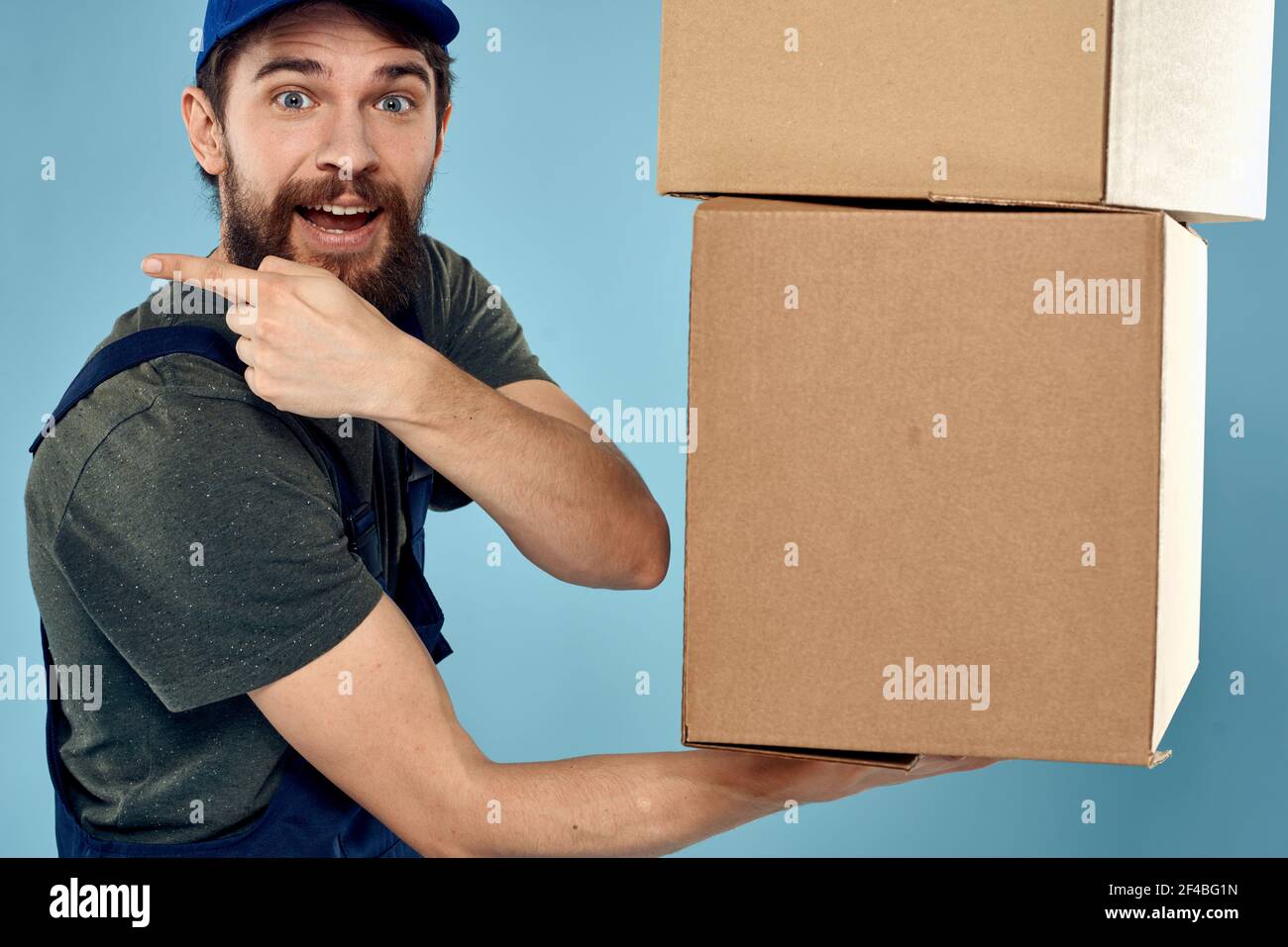 man with boxes service delivery uniform working blue background Stock ...