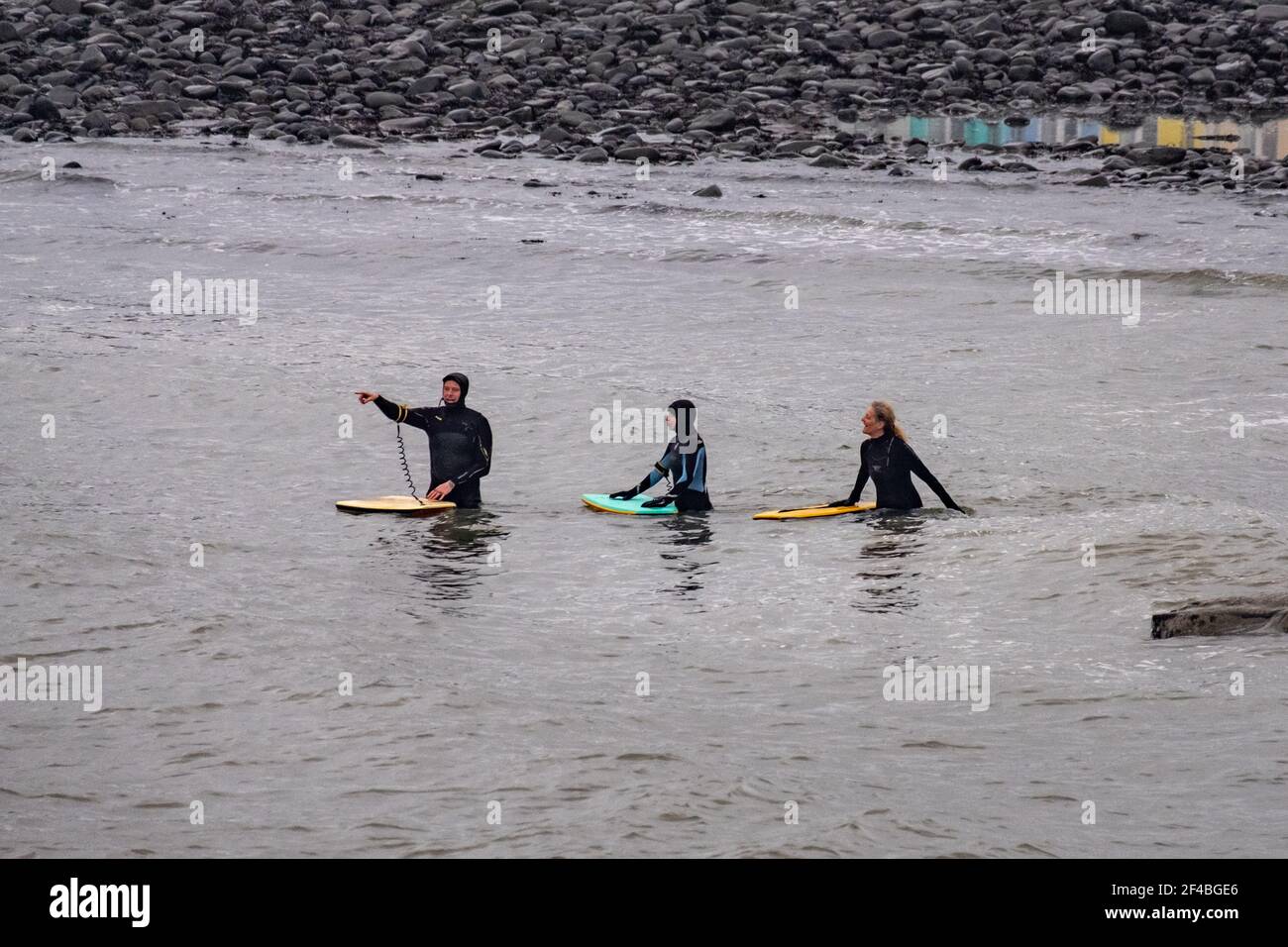 Surfers enjoy the waves in Aberystwyth, Wales. Stock Photo