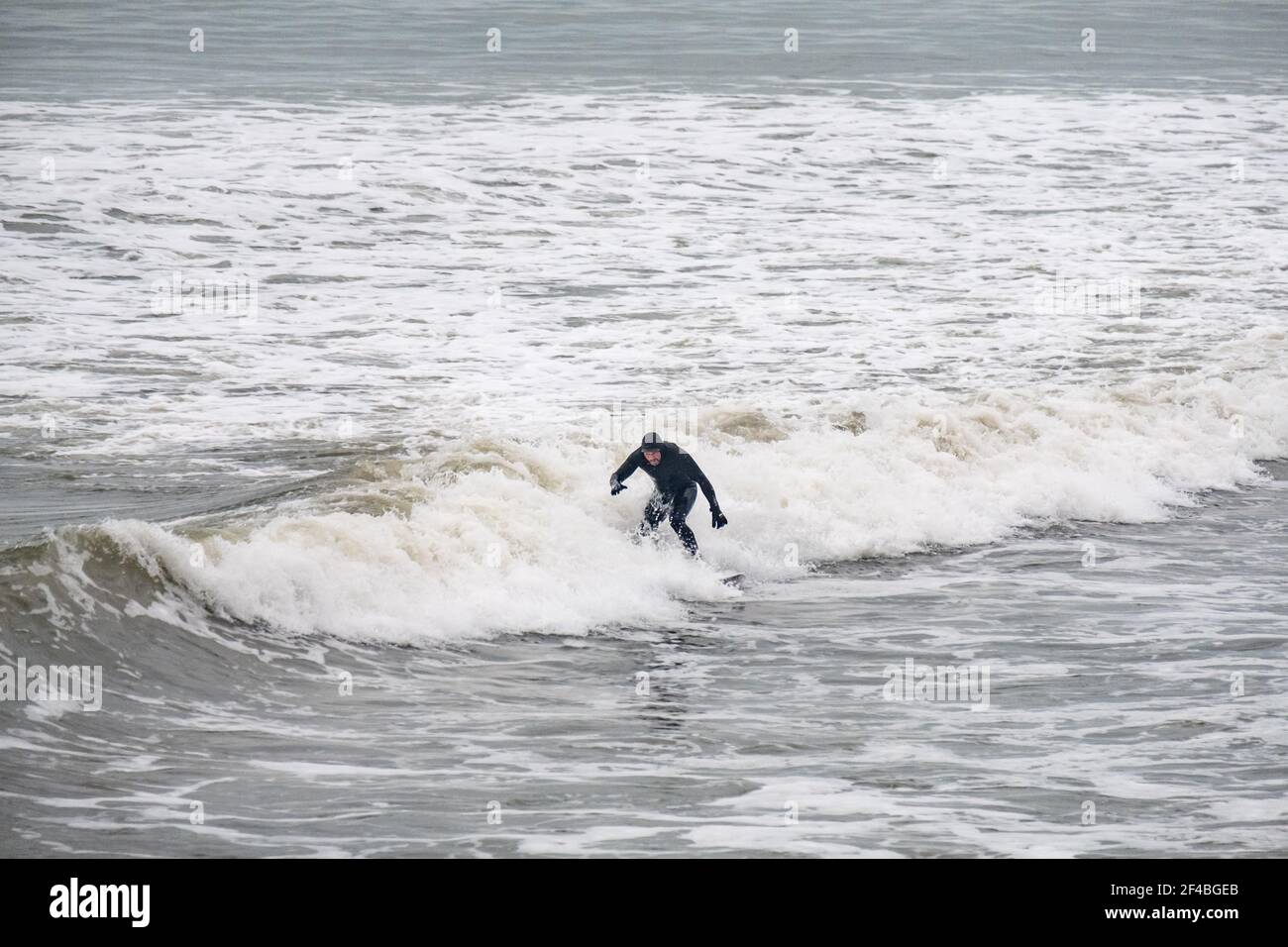 Surfers enjoy the waves in Aberystwyth, Wales. Stock Photo
