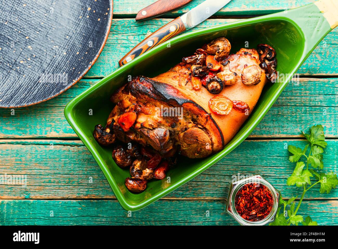 German food meat dish of pork knuckle in baking dish.Braised pork leg