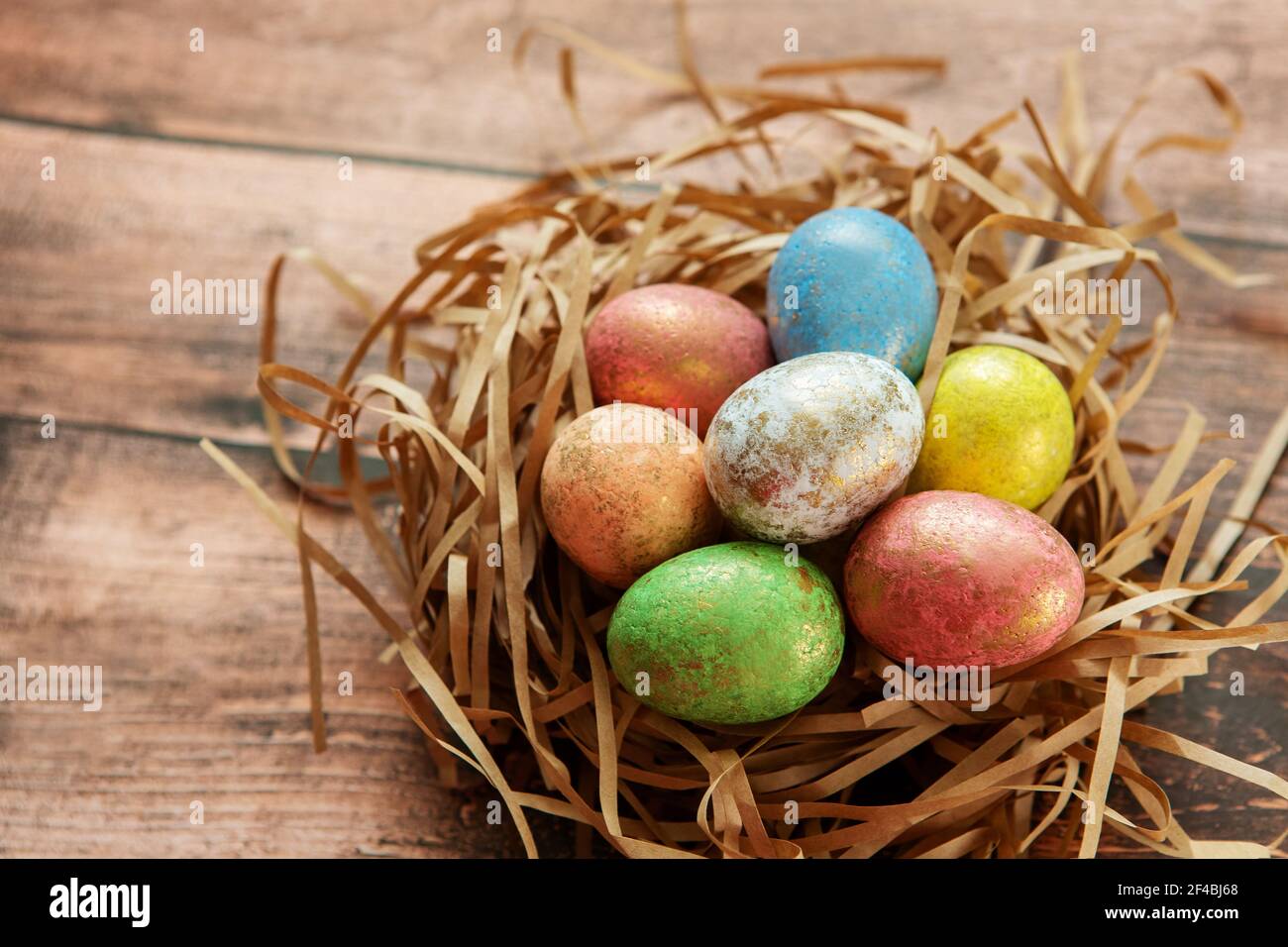 Colorful easter eggs on wooden background. . Happy Easter background. Stock Photo