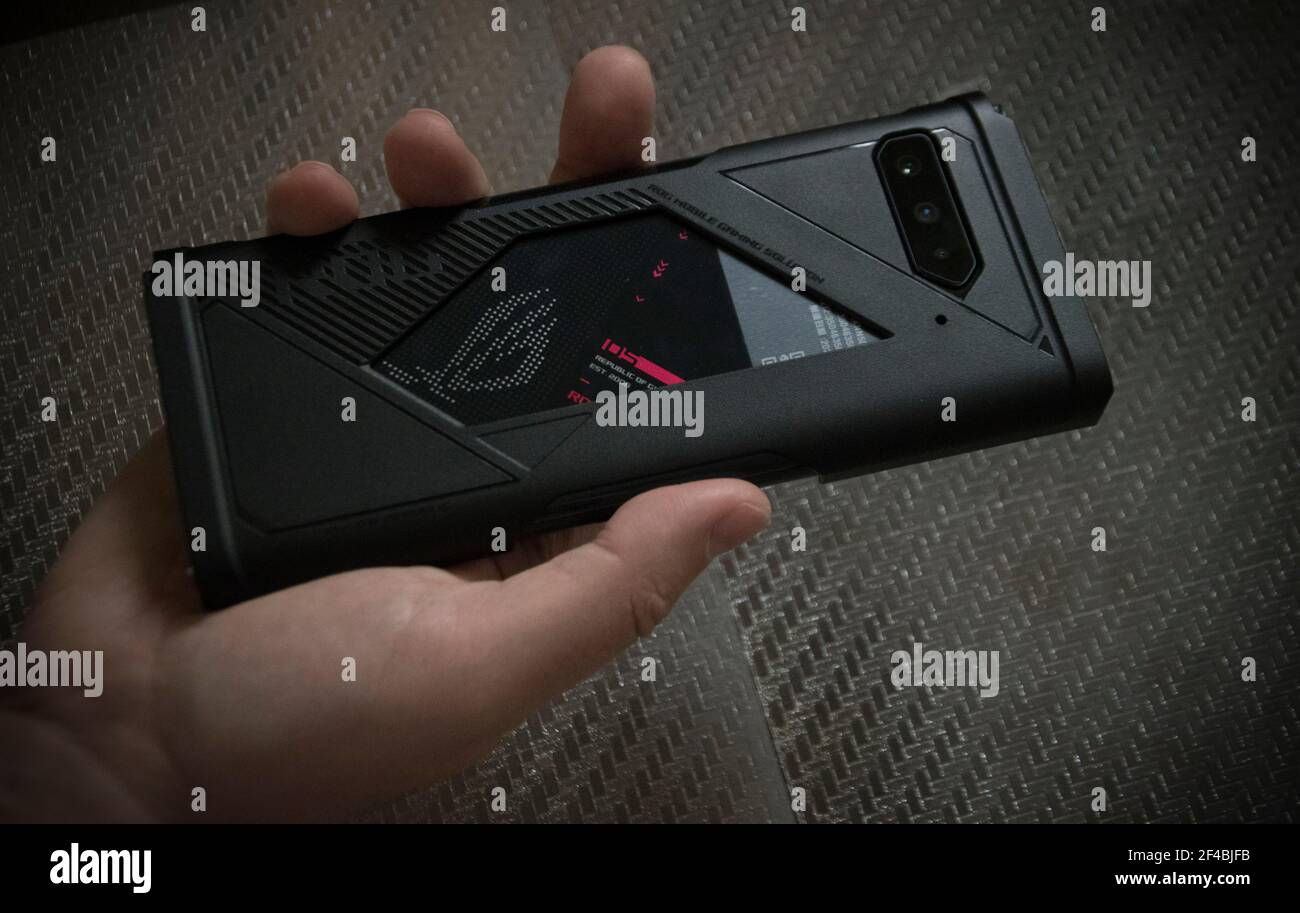 Belgrade, Serbia – March 19th, 2021: Asus ROG Phone 5, view from the back in a man's hand Stock Photo