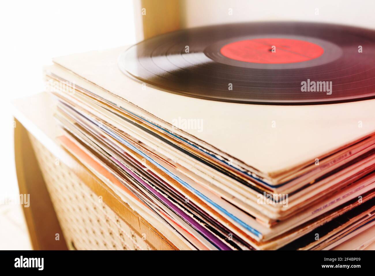 Pile of the vinyl records on the vintage radio player Stock Photo