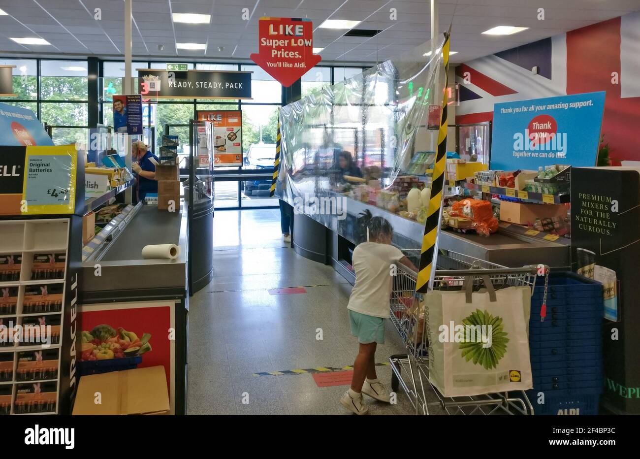 London, United Kingdom - August 21, 2020: Transparent plastic wall shield at Aldi supermarket counters to prevent spread of coronavirus covid-19 disea Stock Photo