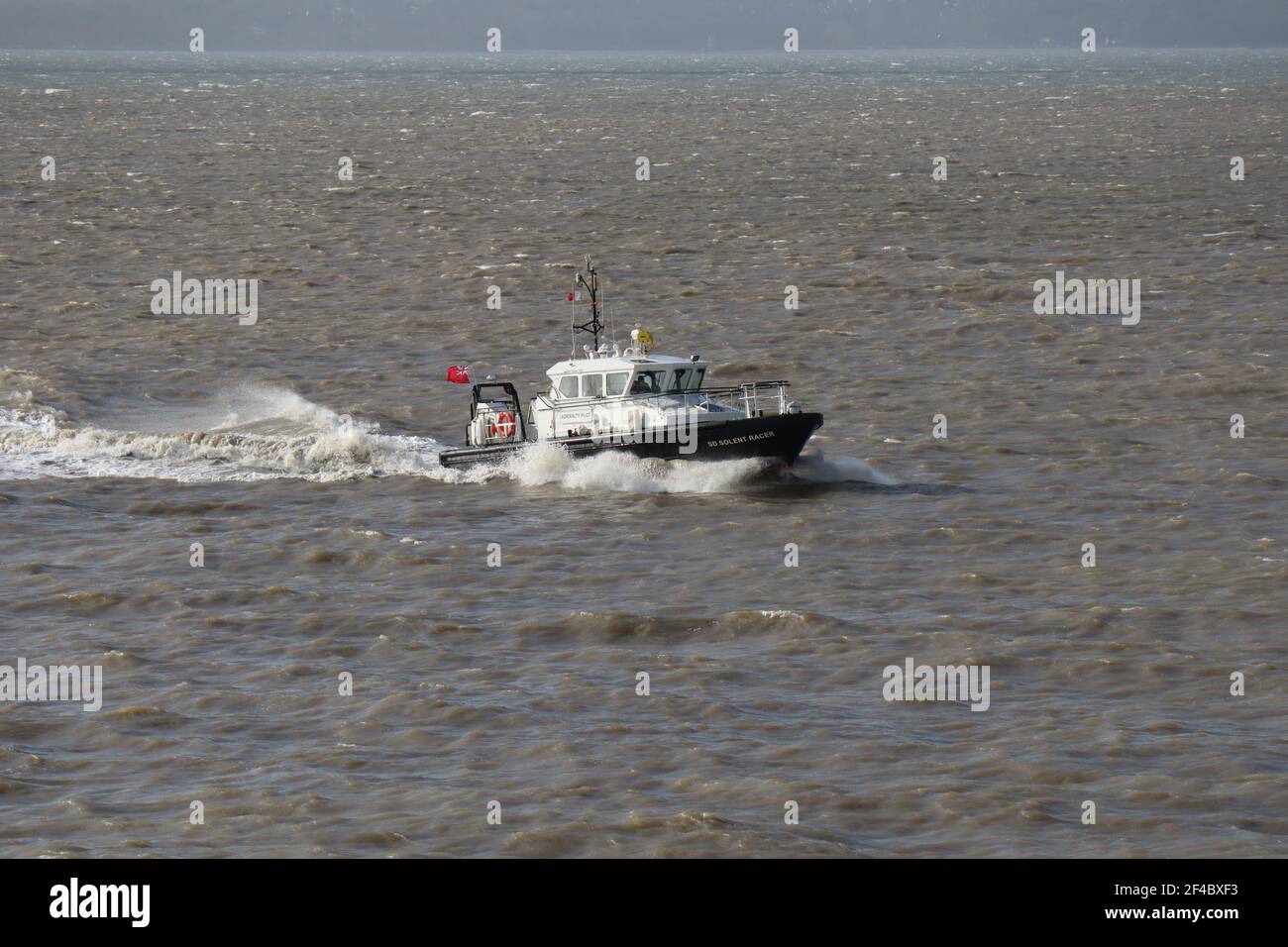 The Admiralty pilot vessel SD SOLENT RACER speeds through the choppy waters of The Solent as it heads back to harbour Stock Photo