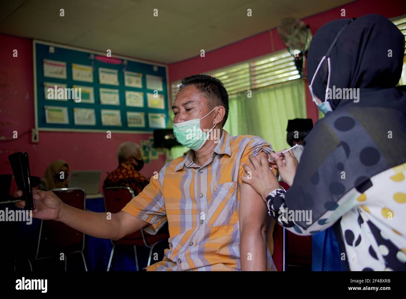 Soppeng, Indonesia. 20th Mar, 2021. A number of teachers received the first stage 19 doses of the Covid vaccine. The Indonesian government through the Ministry of Education and Culture targets the vaccine process for 5 million teachers and educators to be completed by the end of June 2021. (Photo by Moch Farabi Wardana/Pacific Press) Credit: Pacific Press Media Production Corp./Alamy Live News Stock Photo