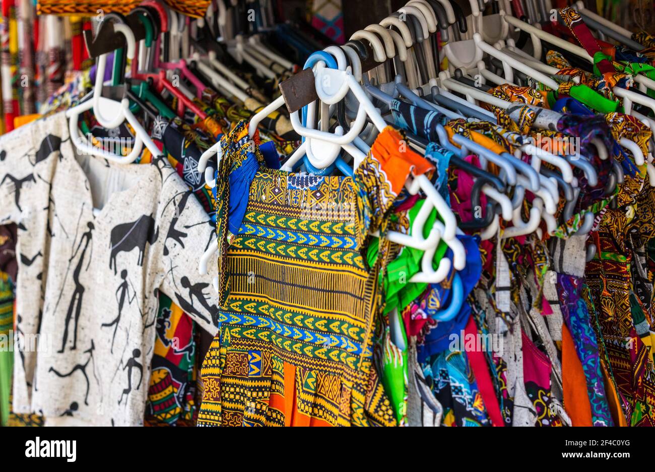 childrens clothing, kids clothes made in traditional African fabric or material hanging up for sale in South Africa, closeup Stock Photo