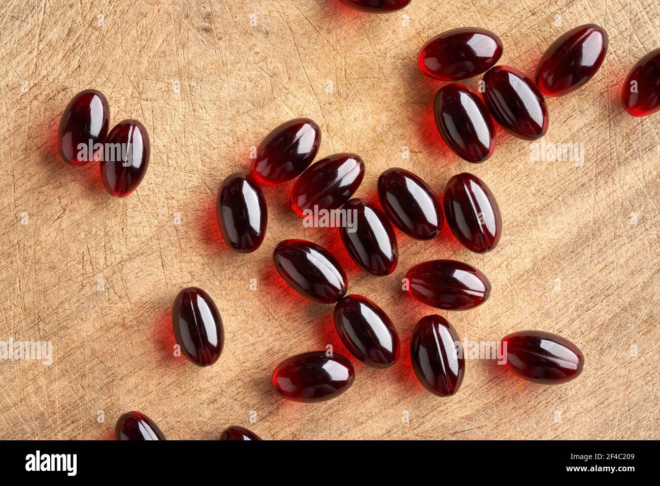 Krill oil pills on a wooden table, top view Stock Photo