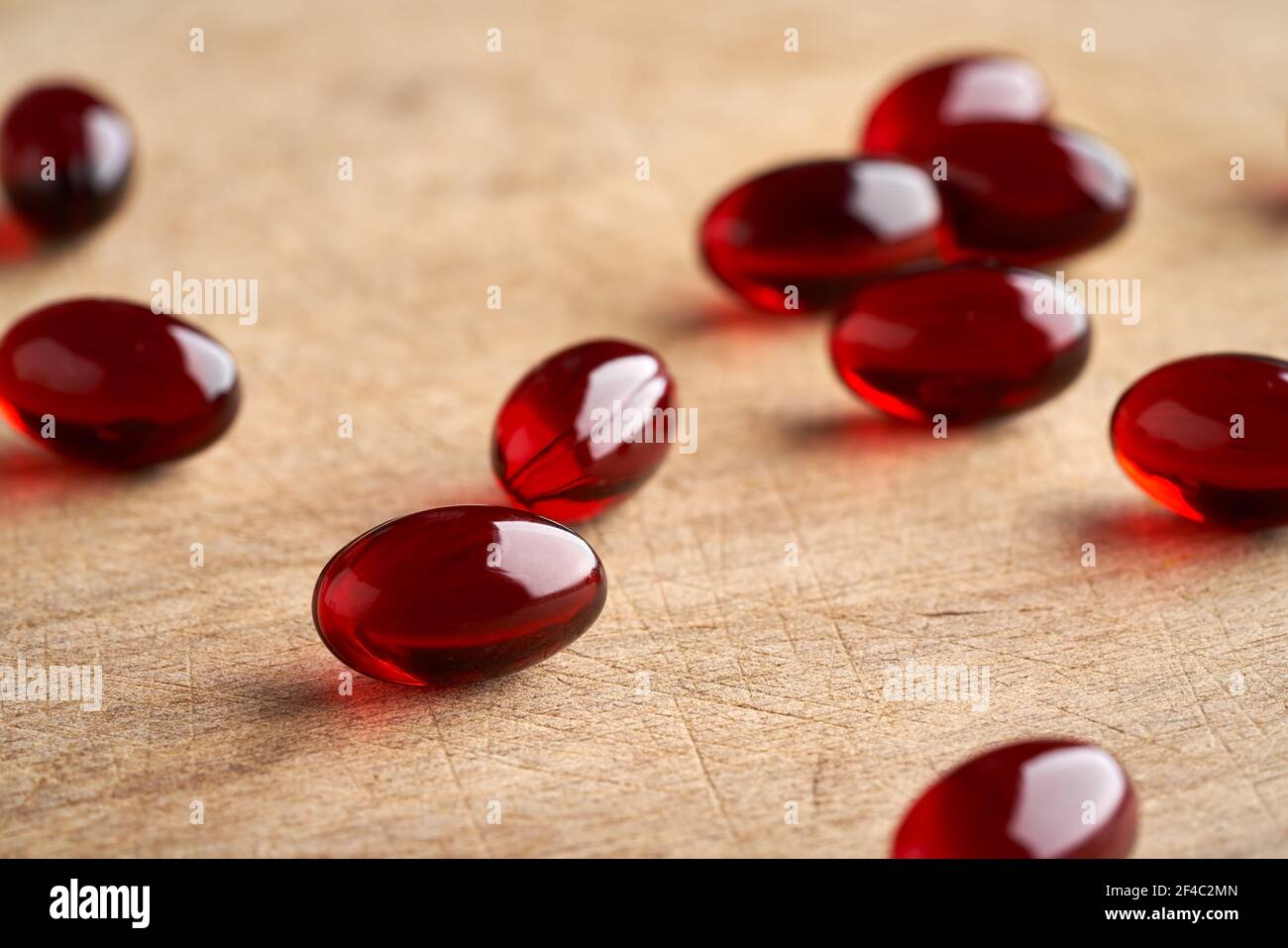 Several krill oil capsules on a wooden background Stock Photo