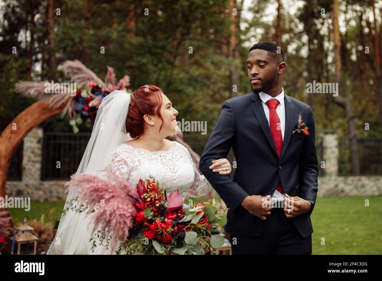 https://c8.alamy.com/comp/2F4C3DG/charming-african-american-groom-with-gorgeous-white-wife-stand-near-decorated-arch-lovely-woman-with-handsome-man-on-wedding-ceremony-smiling-happy-2F4C3DG.jpg
