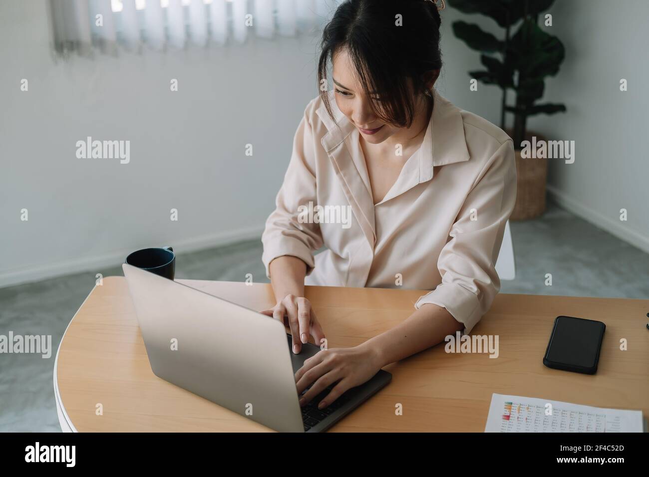 Young businesswoman sitting front open portable laptop computer reading