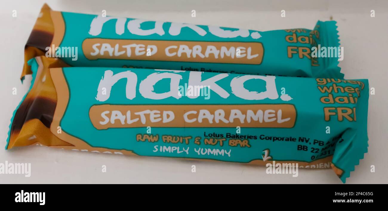 CHESTER, UNITED KINGDOM - 20 MARCH 2021: Two vegan-friendly Nakd Salted Caramel wholefood bars, which are commonly found in the UK Stock Photo