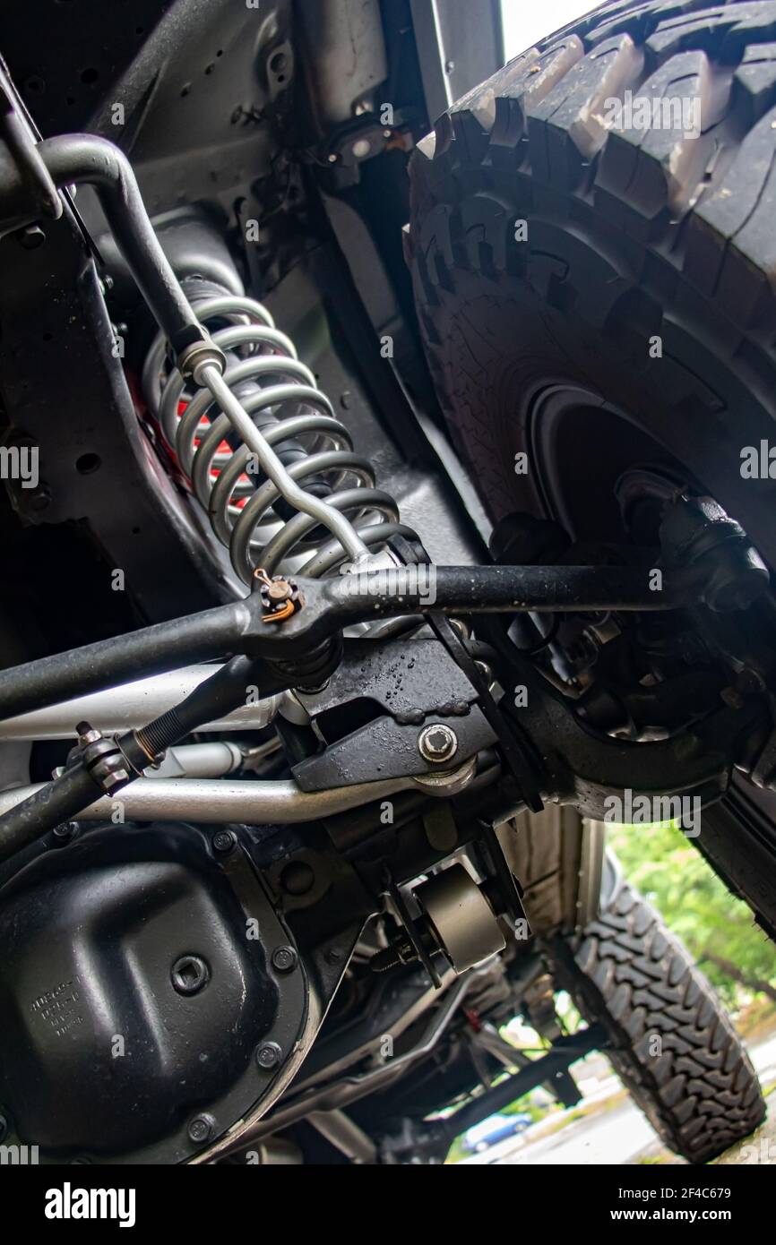 Off-road car chassis with a detailed view of the coil spring at the front wheel. Stock Photo