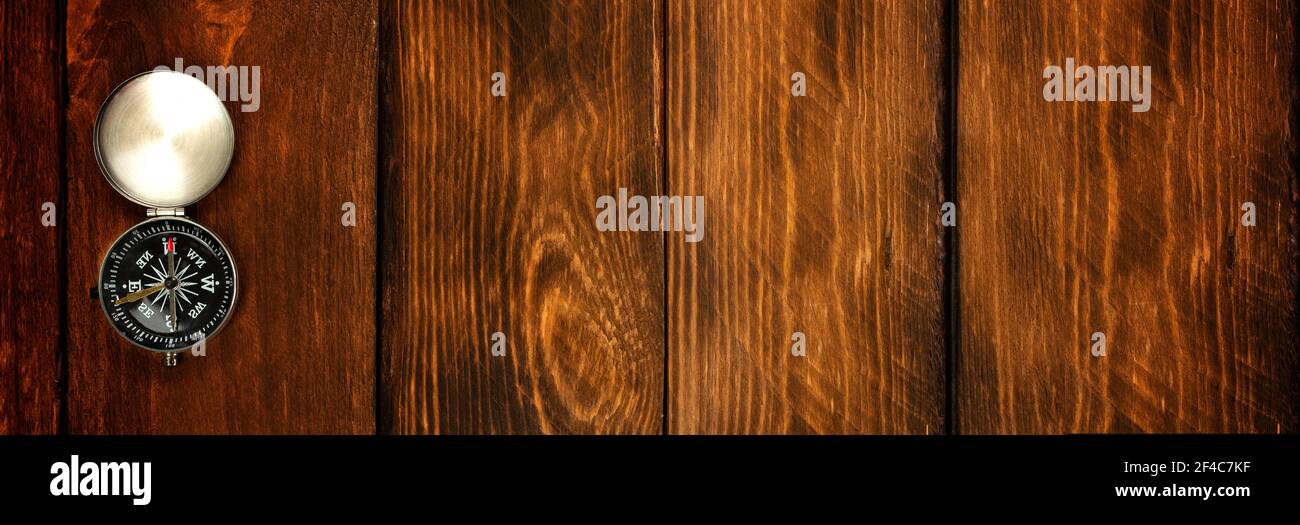 compass on the brown wooden table background. Stock Photo