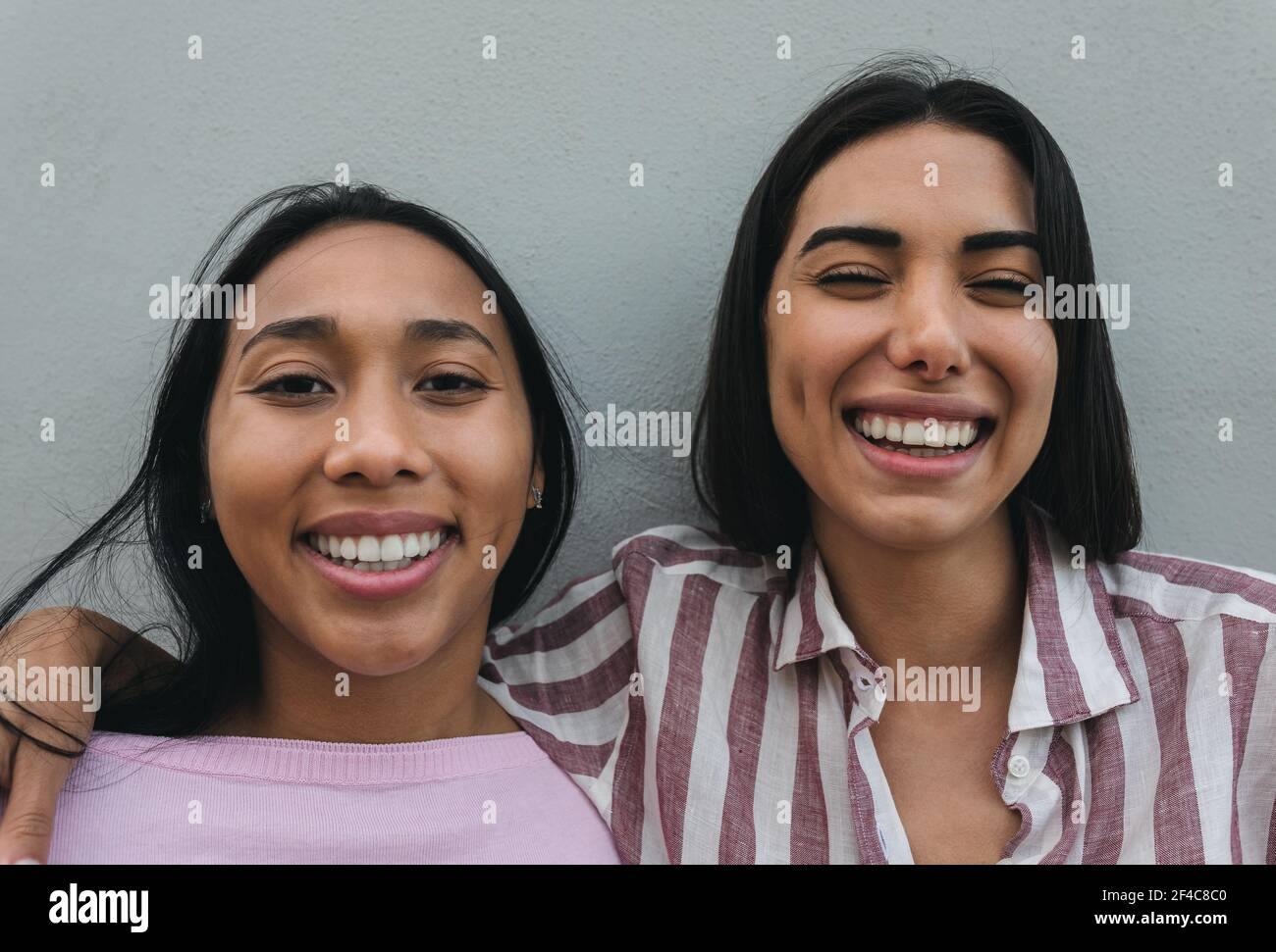 Happy Latin women having fun smiling together in front of camera Stock ...