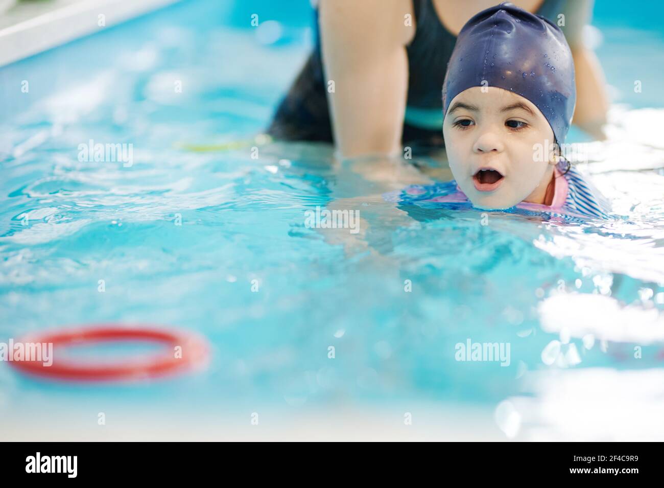 Kid learning to float in swimming pool. Child complete swimming exercise Stock Photo Alamy