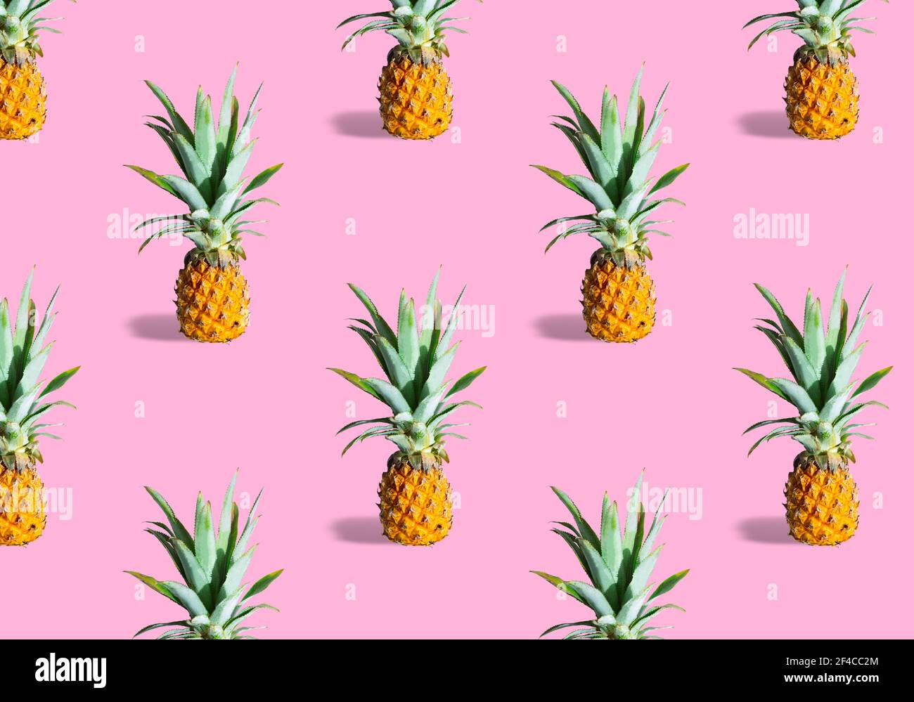 Seamless pattern of fresh ripe pineapples isolated on pink background Stock Photo