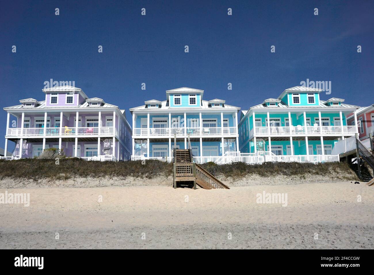 Row of multicolored houses on a sandy beach Stock Photo