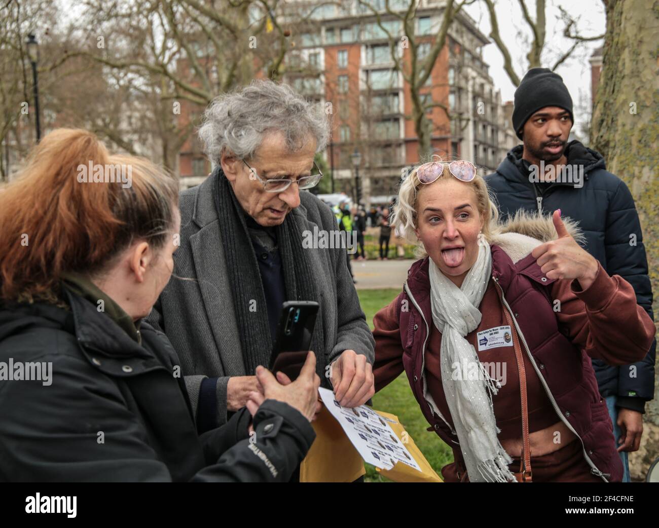 London UK 20 March 2021. Piers Corbyn English weather forecaster, businessman, activist, anti-vaxxer and conspiracy theorist arrives in Hyde Park to take part in todays anti lockdown ,anti vaccine and anti new laws to curb demonstrations ,currently been debated in parliament , giving a fan a sticker with his name and face campaigning for London Mayor . Paul Quezada-Neiman/Alamy Live News Stock Photo