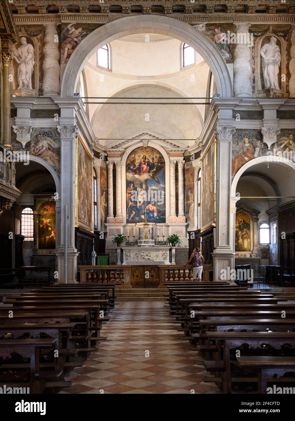 Venice. Italy.  Interior of the Chiesa di San Sebastiano (Church of Saint Sebastian), the high altarpiece, depicting the Virgin and Child in Glory wit Stock Photo