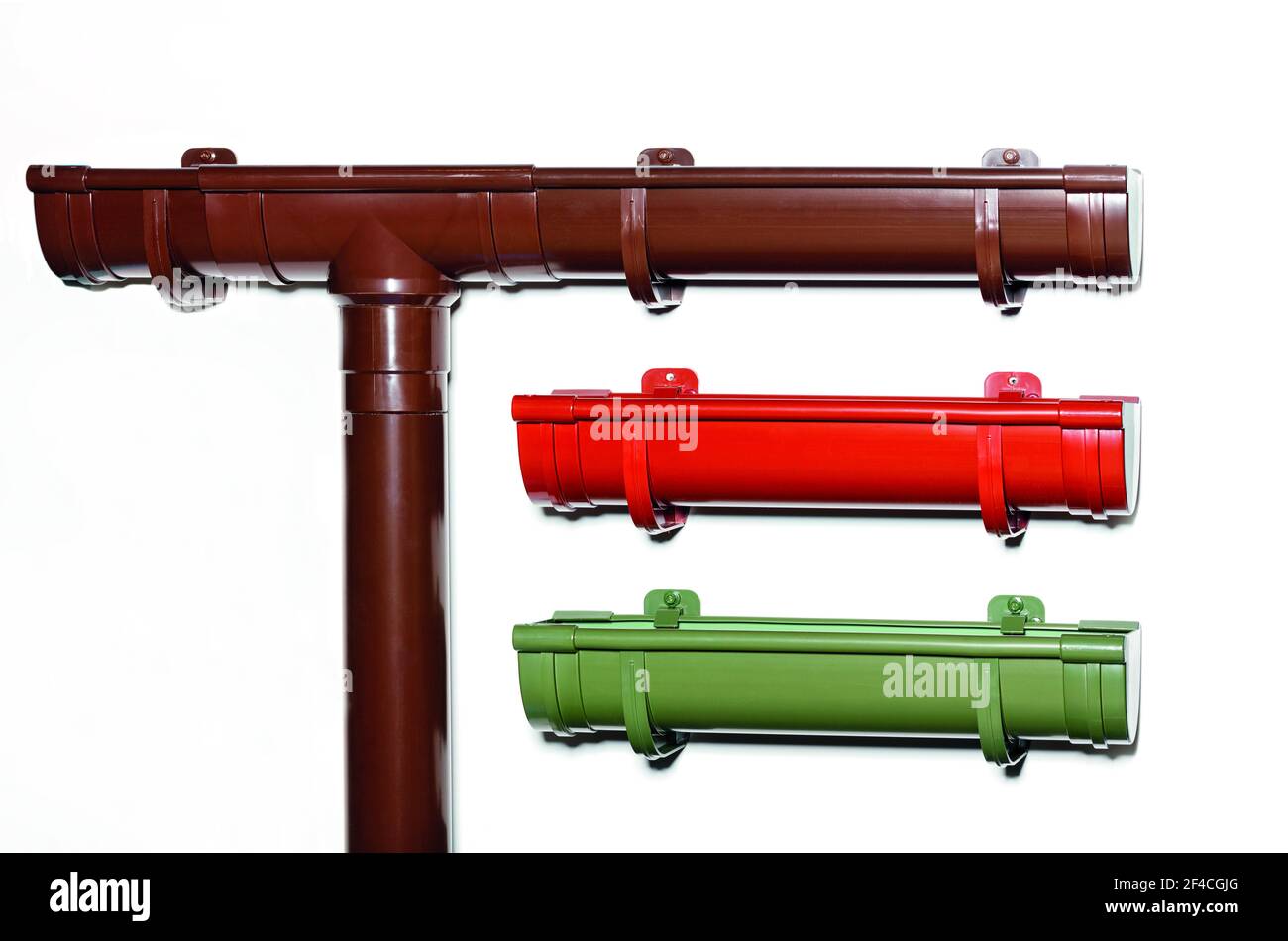 Plastic gutters for draining water from the roof of the house, brown, red, green. Downpipes, close-up, copy space. Stock Photo