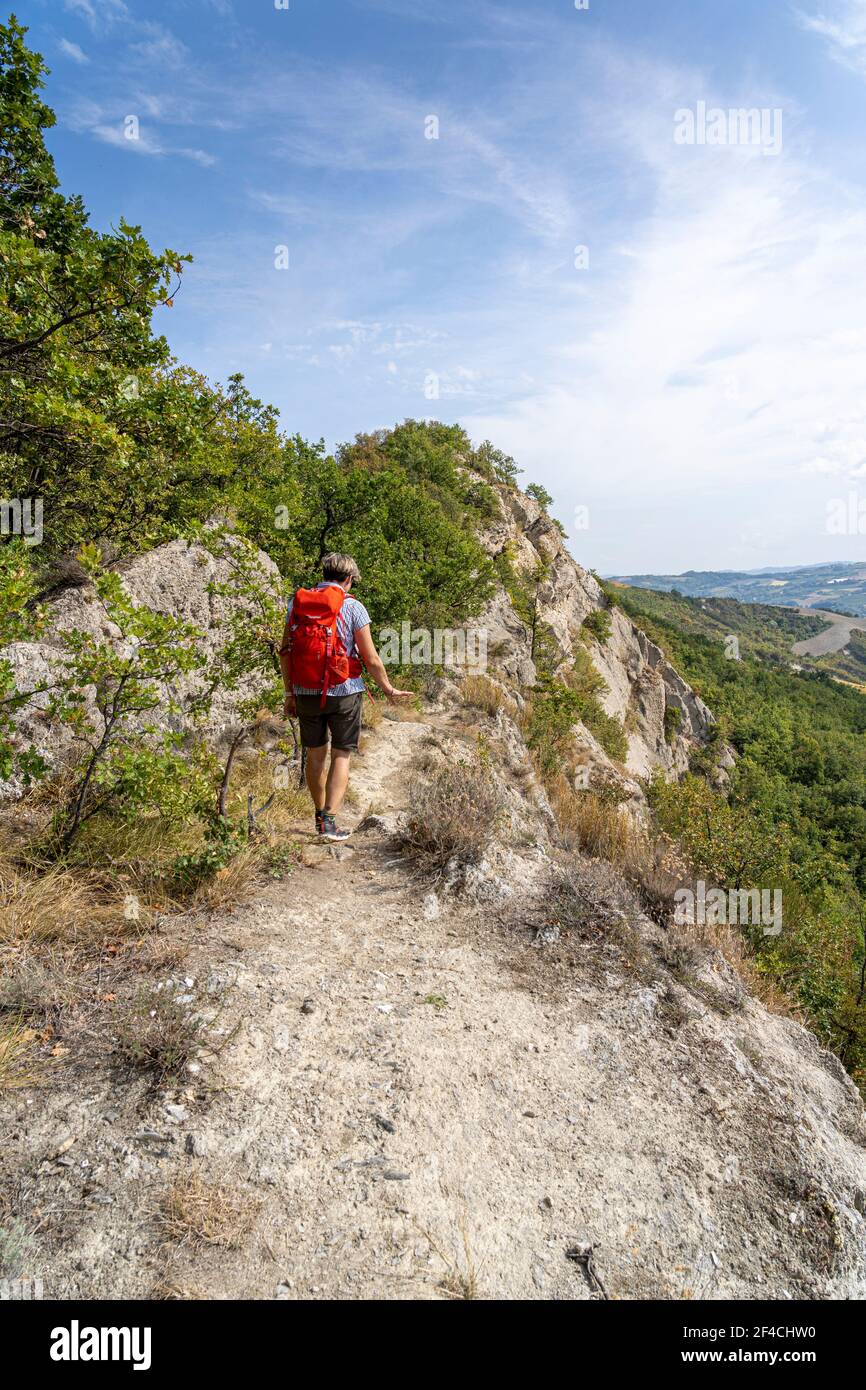One woman hiking in the Parco regionale della vena del gesso romagnola. Brisighella, Borgo Rivola, Borgo Tossignano. Emilia Romagna, Italy, Europe. Stock Photo