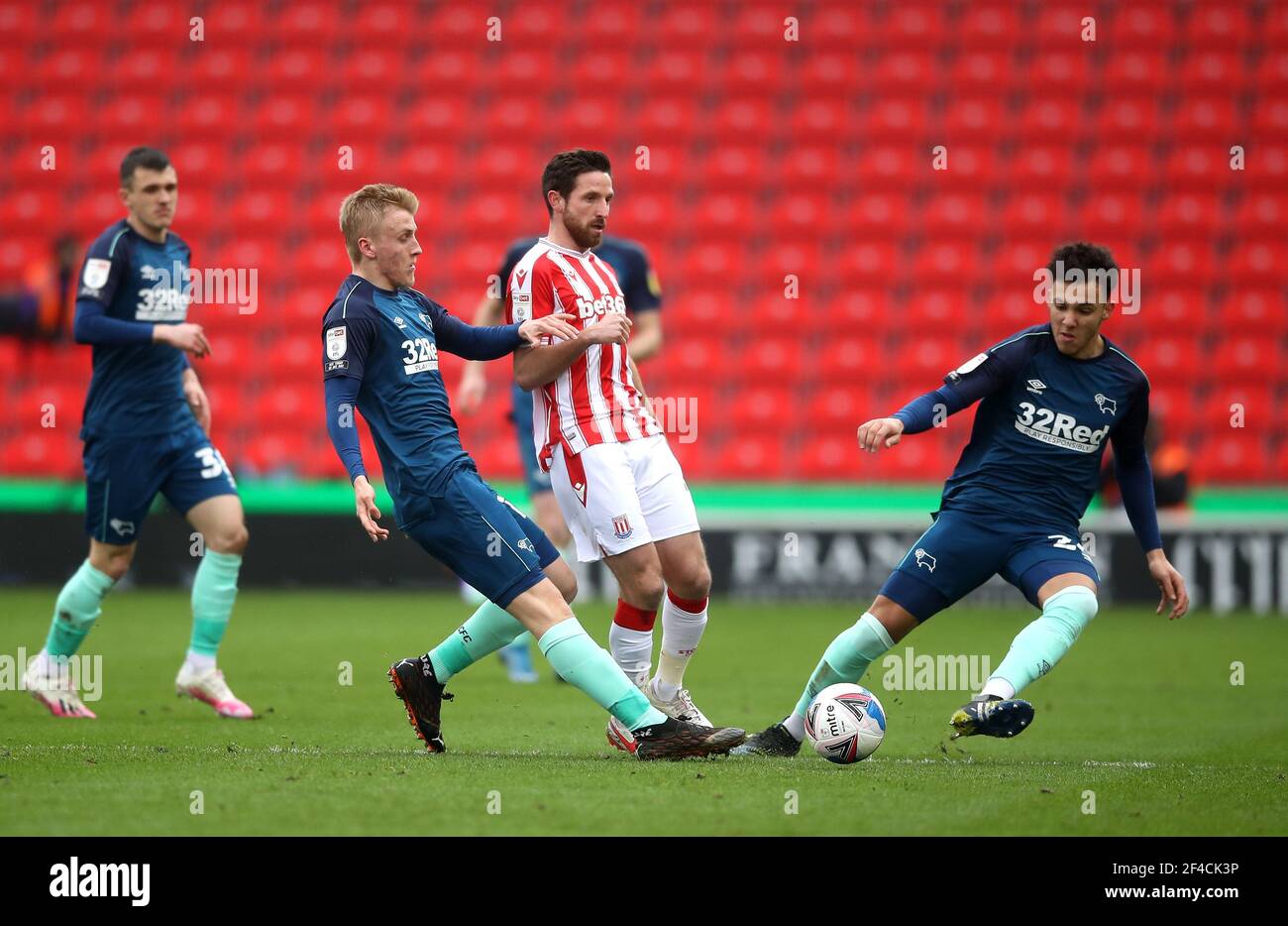 Stoke City's Joe Allen (centre) battles for the ball Derby County's Louie Sibley and Lee Buchanan during the Sky Bet Championship match at the bet365 Stadium, Stoke-on-Trent. Picture date: Saturday March 20, 2021. Stock Photo