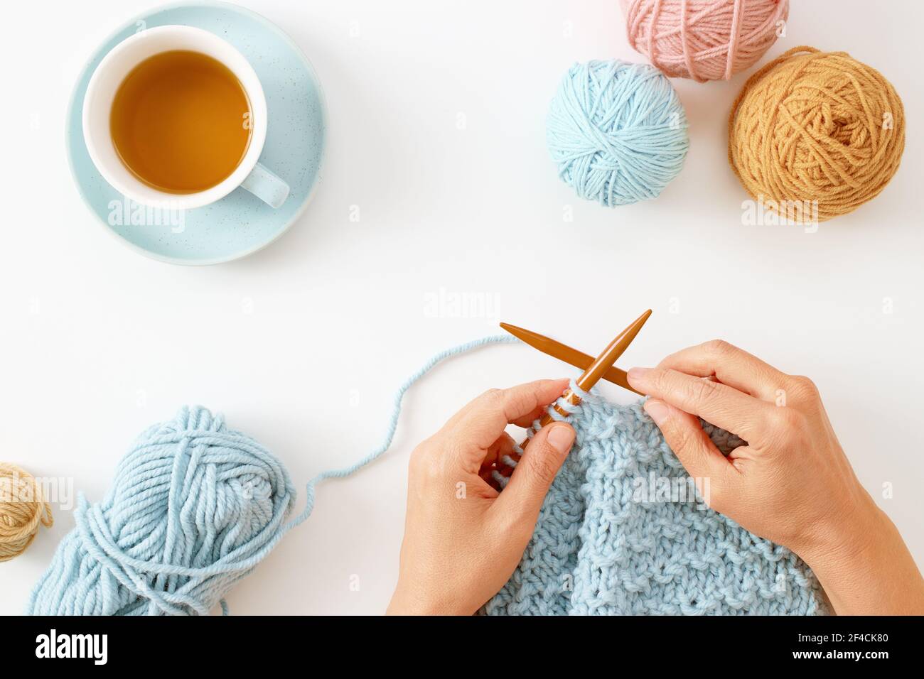 Woman hands knitting hat with needles and yarn Stock Photo