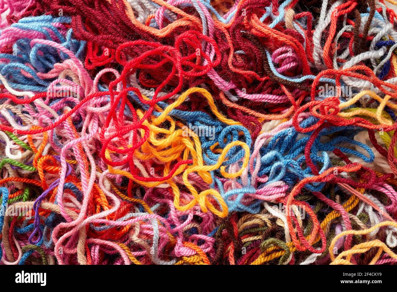 Colorful collection of wool for knitting and weaving. Full frame shot of multi colored yarn. Stock Photo
