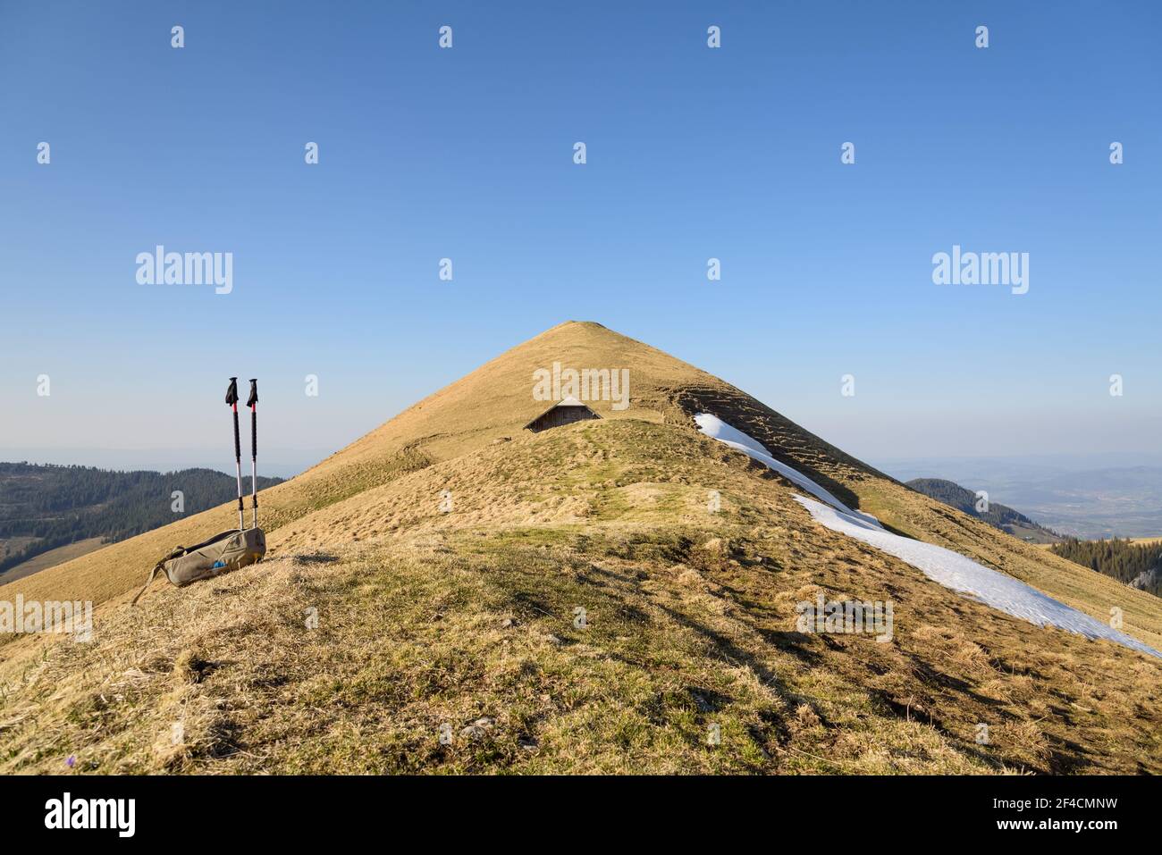 Shelter, hut or cottage on a hill and walking sticks in the Gantrisch Nature Park, Canton of Bern, Bernese Oberland, Swiss Alps, Switzerland, CH Stock Photo