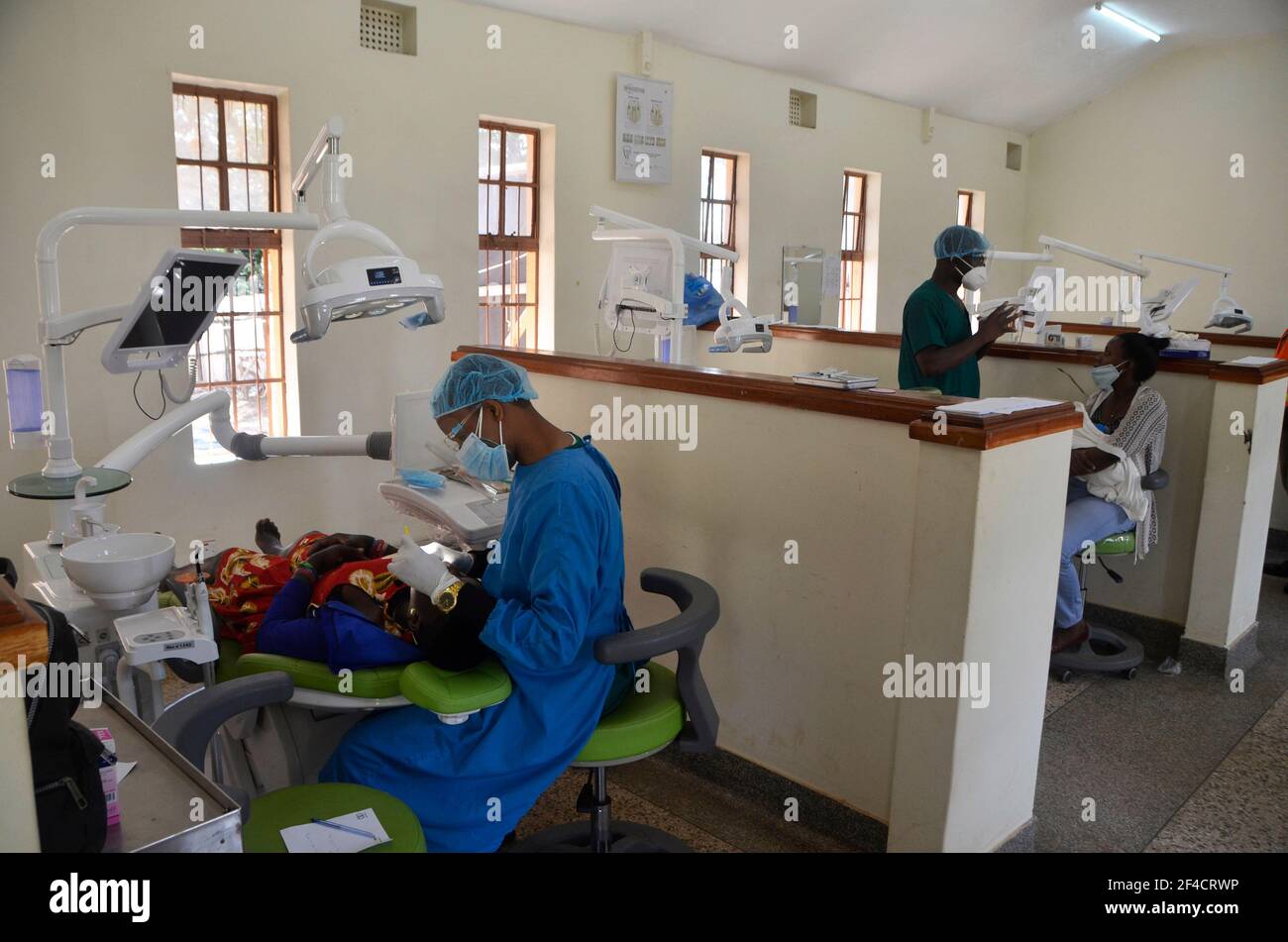 (210320) -- KAMPALA, March 20, 2021 (Xinhua) -- Health workers treat patients during a free dental clinic event held to mark the World Oral Health Day at Makerere University in Kampala, Uganda, March 20, 2021. World Oral Health Day is celebrated every year on March 20 to promote worldwide awareness of oral diseases and the importance of oral hygiene. (Photo by Nicholas Kajoba/Xinhua) Stock Photo