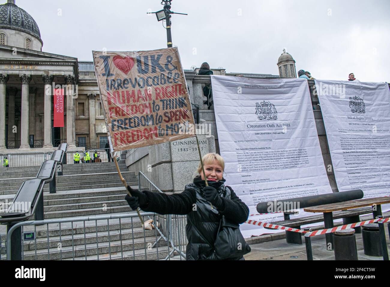 TRAFALGAR SQUARE LONDON, UK 20 March 2021.  Protesters unfurl large banners showing the Bill of Rights of 1688 and the Coronation Oath Act of 1688 as they demonstrate  against the government policing bill which is being introduced in Parliament. MPs have voted to pass the PCSC Police Crime Sentencing Courts Bill will hand the police sweeping new powers to crack down on non-violent protest, including imposing time limits on duration and maximum noise levels that can be allowed. Credit amer ghazzal/Alamy Live News Stock Photo
