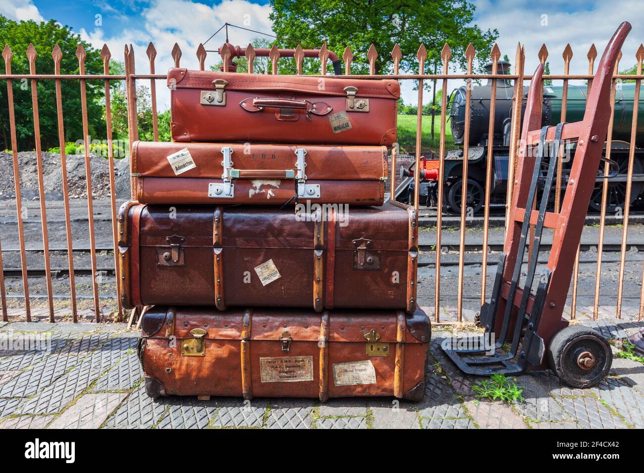 Old leather suitcases and Porter's trolley on the station platform on the Severn Valley Railway, Worcestershire, England Stock Photo