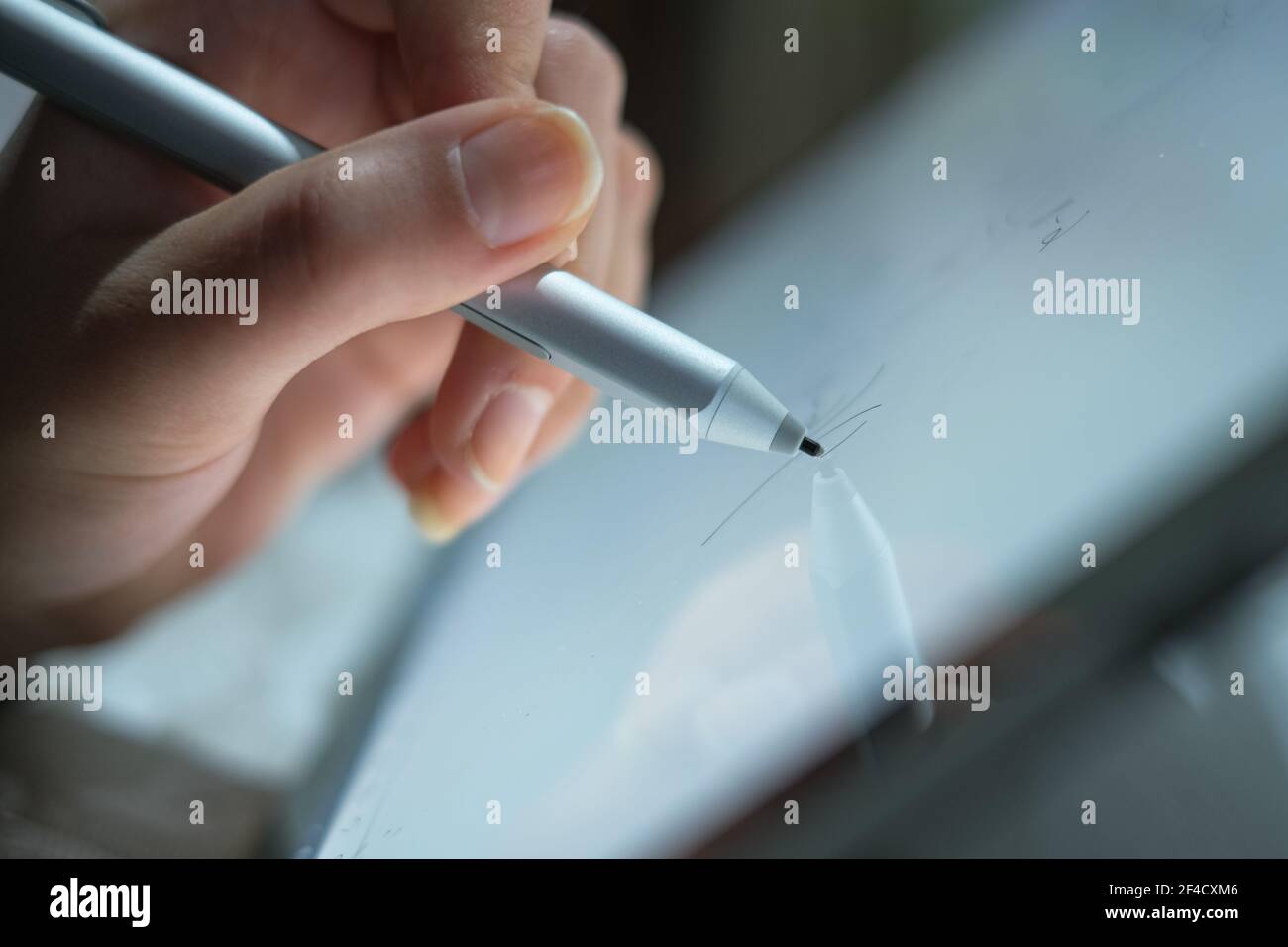 Woman hand view while using graphics tablet stylus for home smart working,digital technology Stock Photo