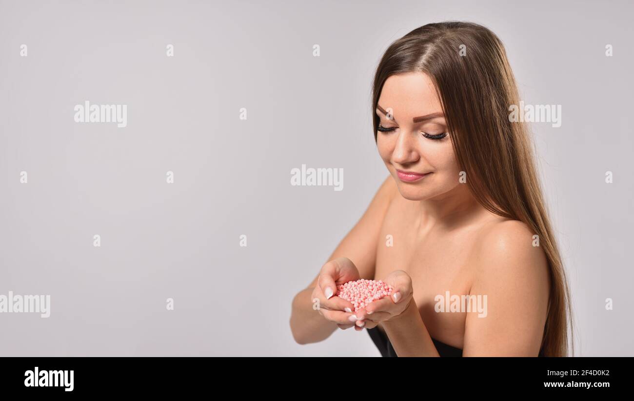 Young woman holding depilation wax in hands, body care and beauty concept Stock Photo