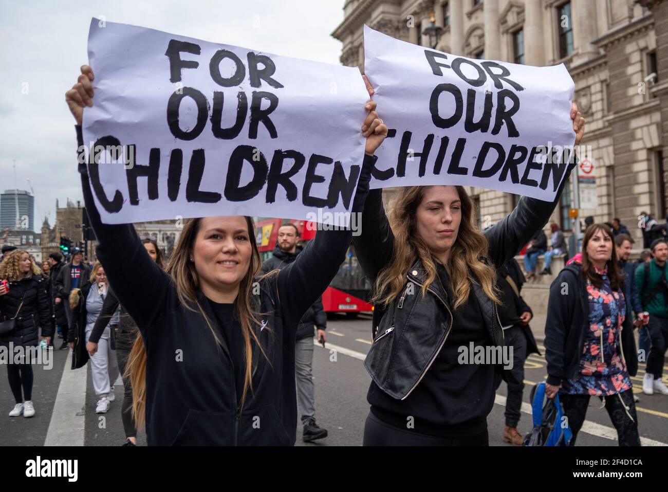 Westminster, London, UK. 20th Mar, 2021. Anti-lockdown protesters have gathered around Parliament and Whitehall. Large numbers of protesters have marched around Westminster, bringing traffic to a standstill in Whitehall and Parliament Square. Females with signs stating For our children Stock Photo