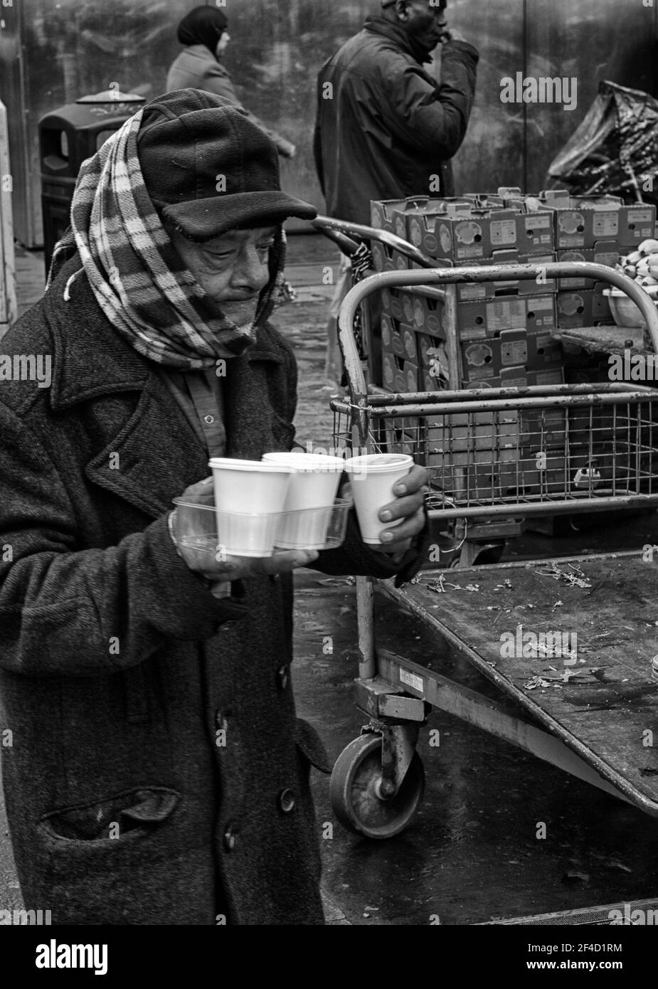 Tea up. Man carrying cups of tea Whitechapel Market. Mile End Road