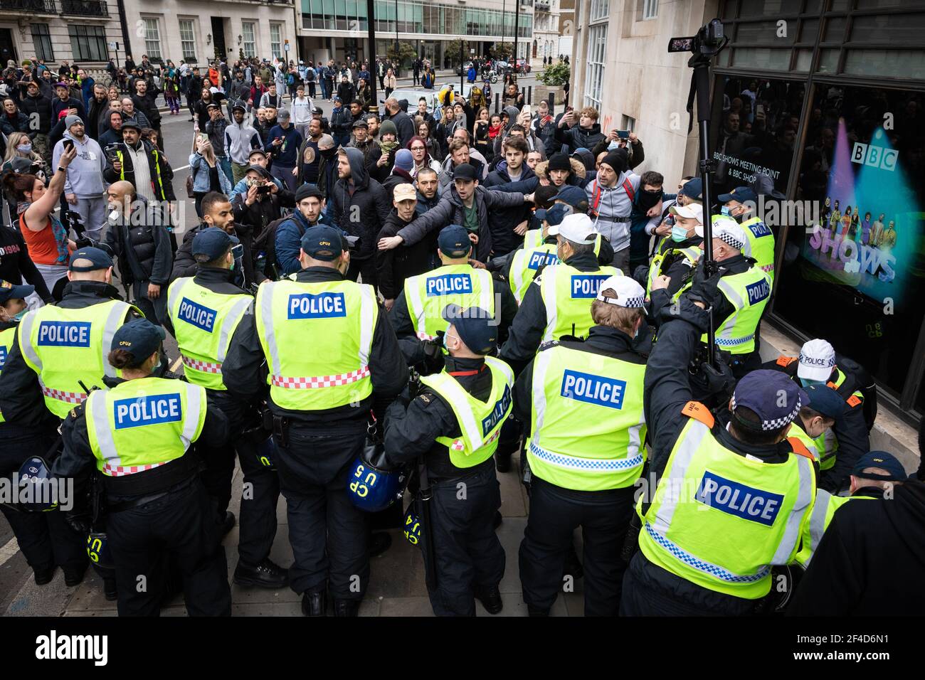 London, UK. 20th Mar, 2021. Police try to stop protesters from getting close to the BBC during a anti-lockdown march. A World Wide Rally For Freedom is organised a year after lockdowns were introduced. Credit: Andy Barton/Alamy Live News Stock Photo