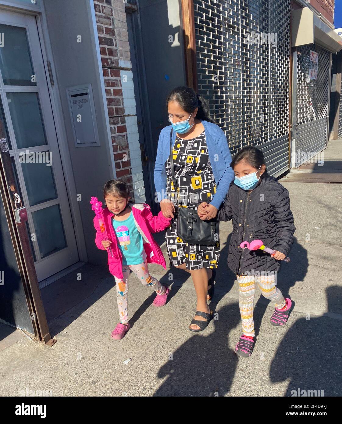 Hispanic grandma with grandchildren walking along Church Avenue during the Covid-19 pandemic in Brooklyn, New Yortk. Stock Photo