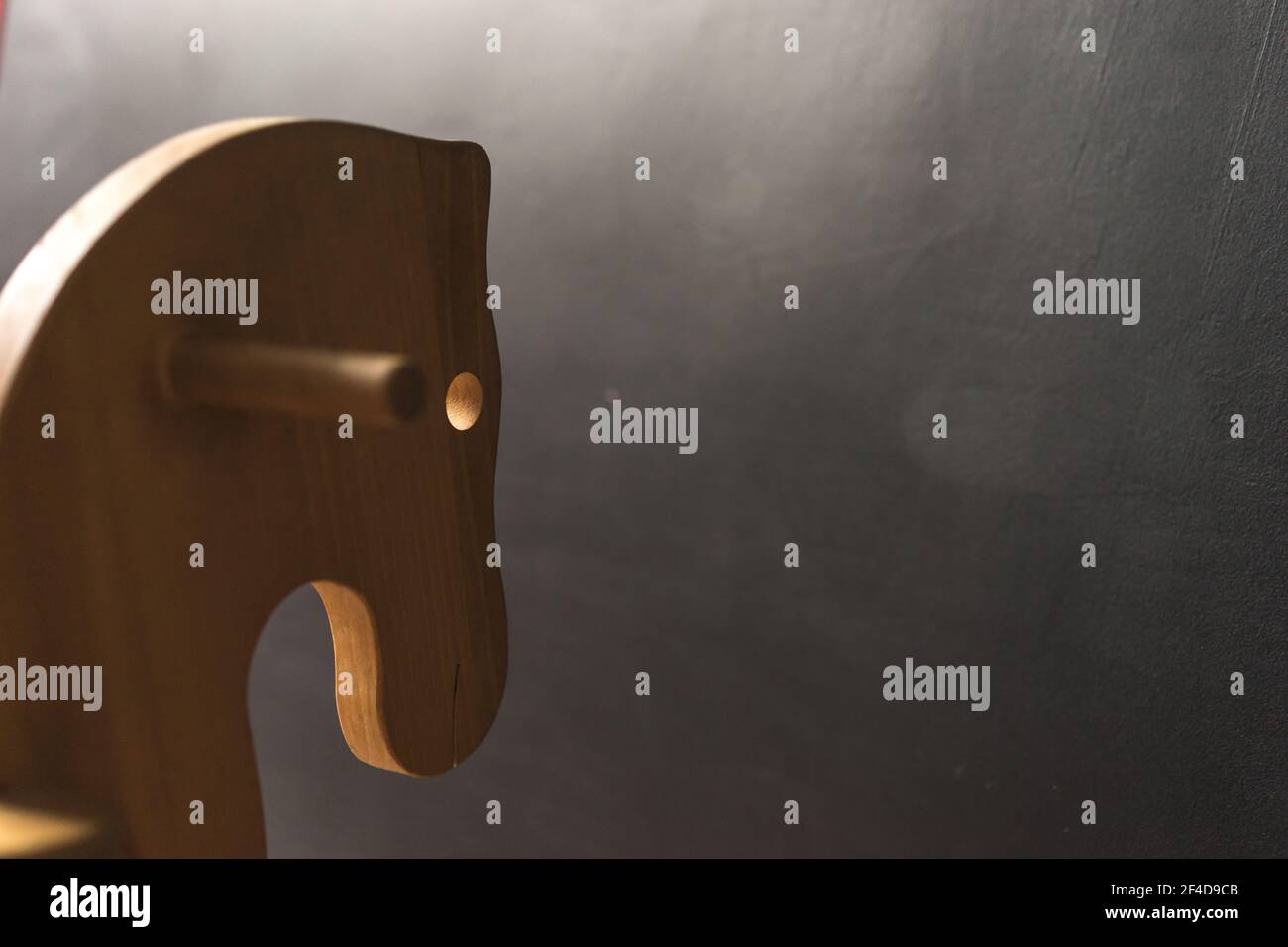 handmade wooden horse toy for children at the dark wall, copy paste ...