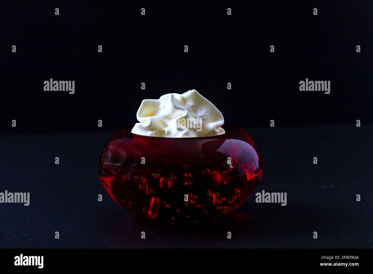 Whipped cream inside a red glass container Stock Photo Alamy